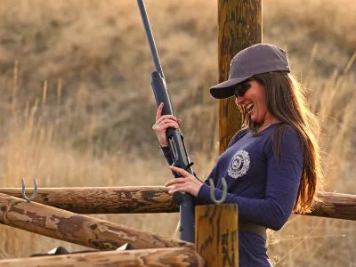 A shooter admires a shotgun