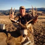 Hunter proudly displays large deer.