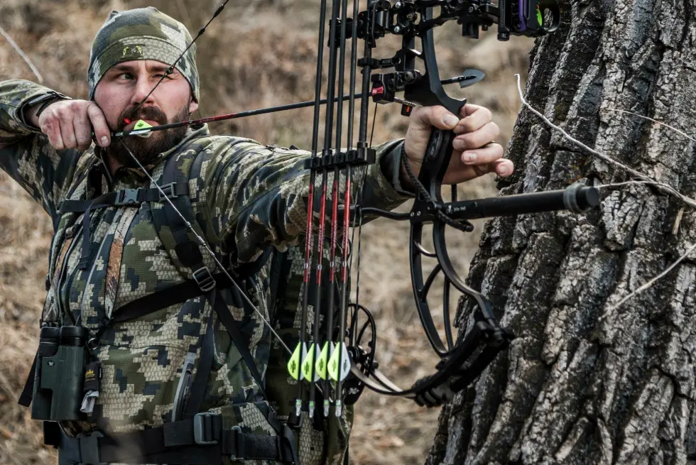 A bow hunter takes aim